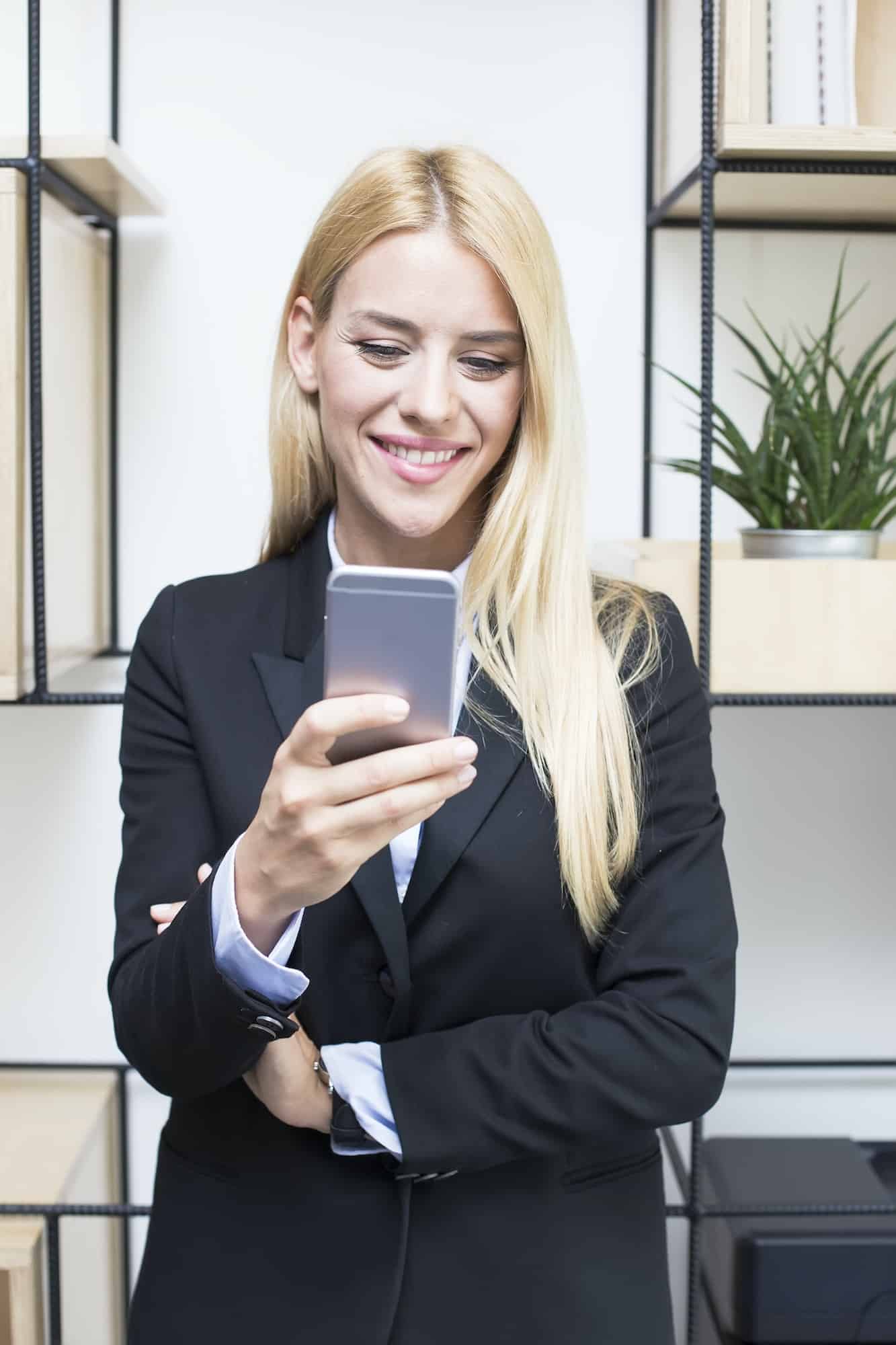 Attractive young businesswoman holding a mobile phone