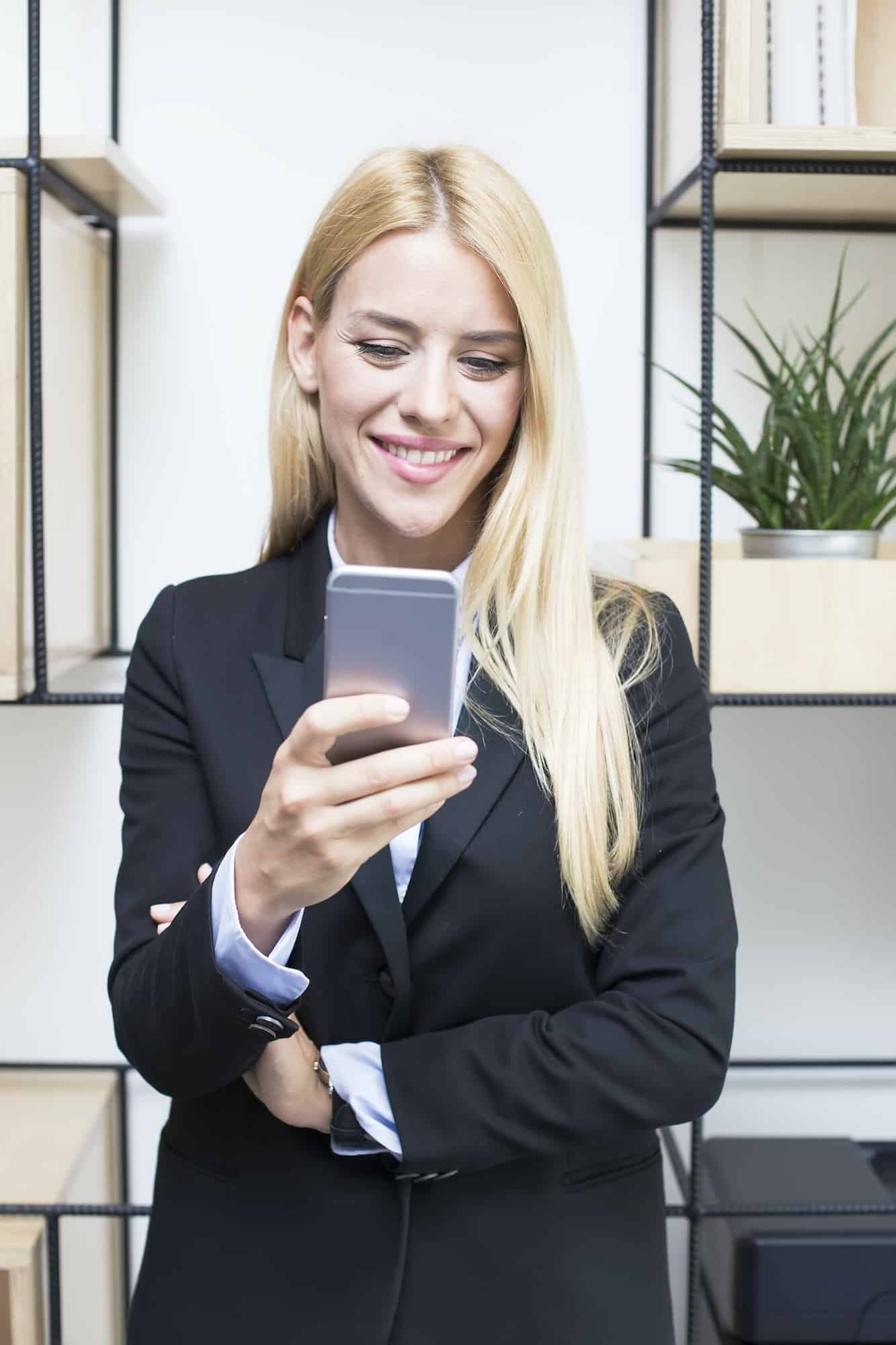 Attractive young businesswoman holding a mobile phone
