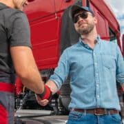 Happy and Satisfied Truck Driver Shaking His Mechanics Hand